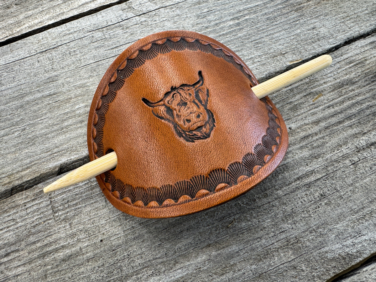 Hand stamped highland cow leather hair barrette with shell border and bamboo hair stick.