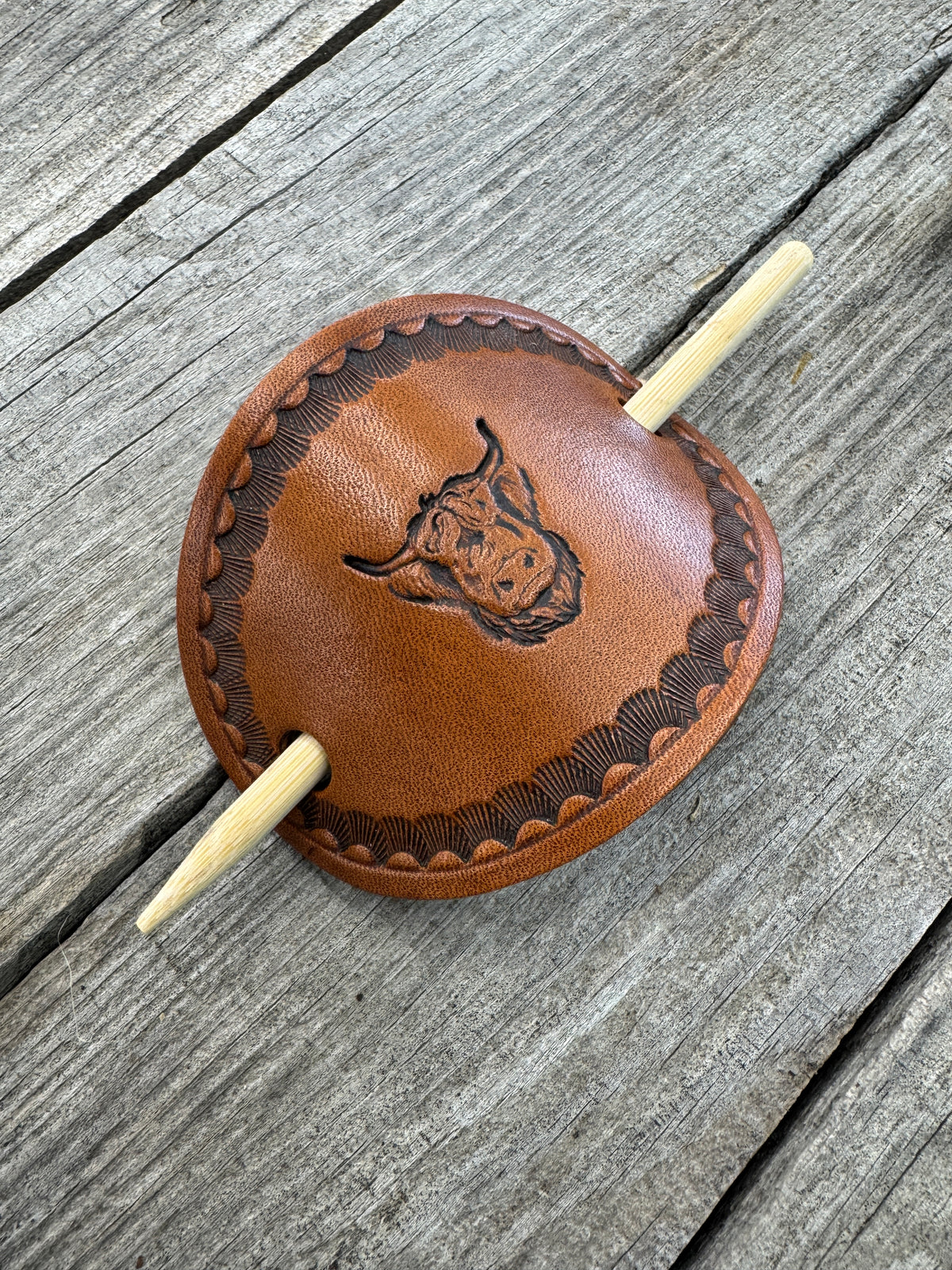 Hand stamped highland cow leather hair barrette with shell border and bamboo hair stick.