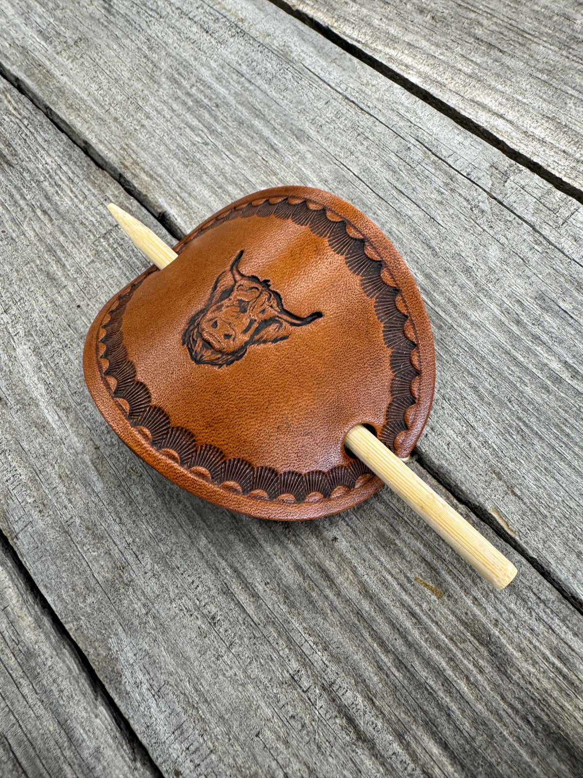 Hand stamped highland cow leather hair barrette with shell border and bamboo hair stick.