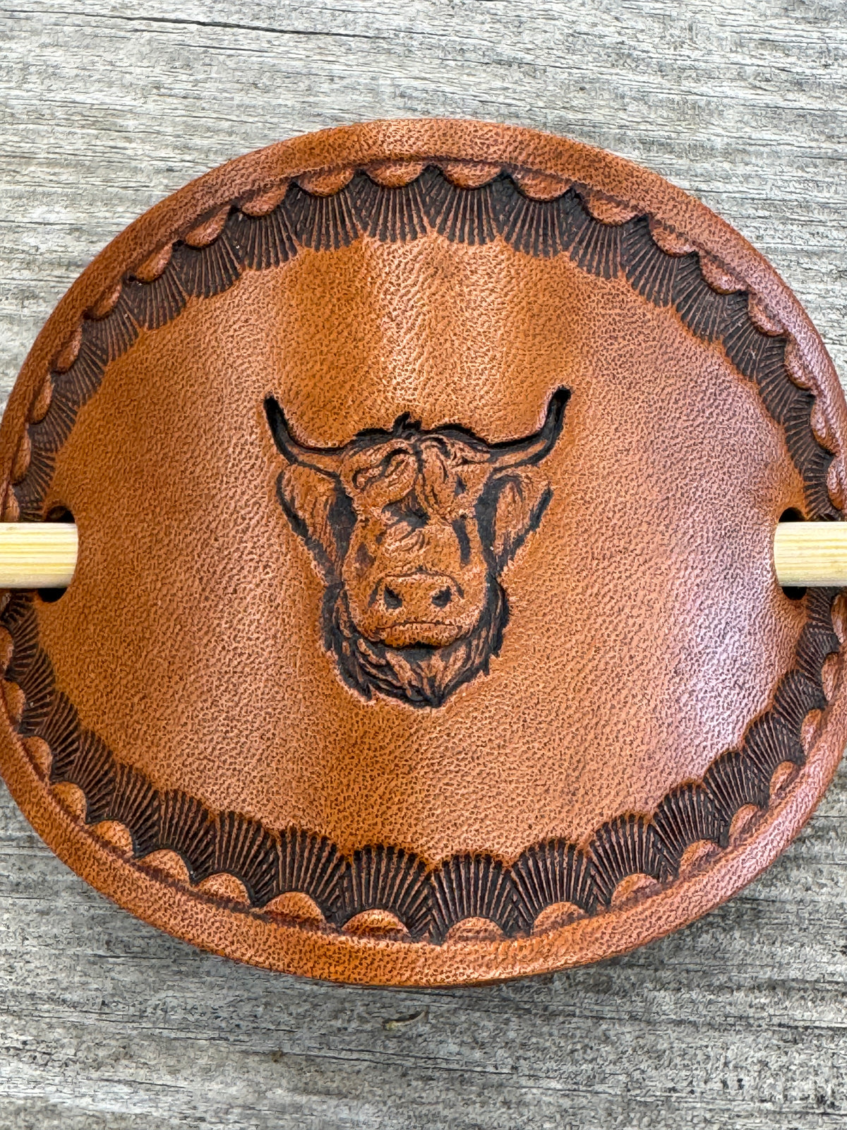 Hand stamped highland cow leather hair barrette with shell border and bamboo hair stick.