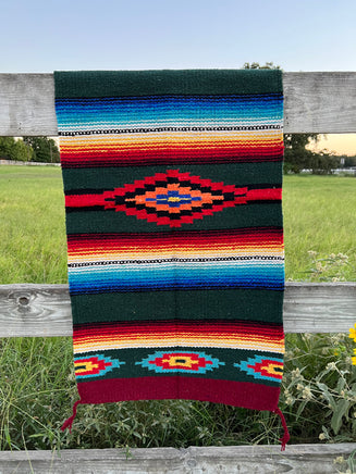 20 inch by 40 inch dark green southwestern accent rug