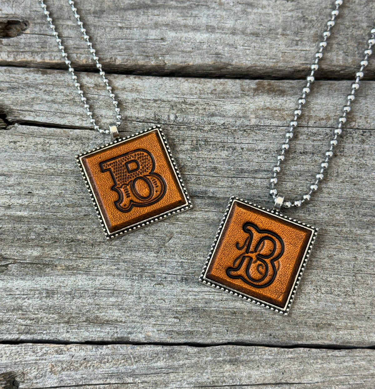 Letter B leather initial necklaces in Western Block and Floral Script fonts on silver ball chains