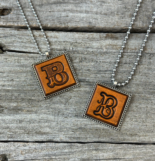Letter B leather initial necklaces in Western Block and Floral Script fonts on silver ball chains