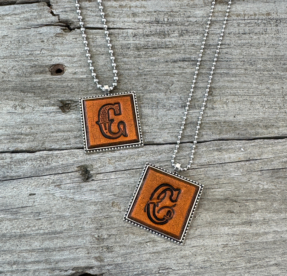 Letter C leather initial necklaces in Western Block and Floral Script fonts on silver ball chains