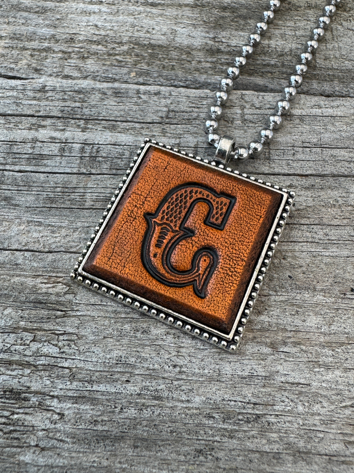 Western Block letter C hand-stamped leather pendant necklace in a silver-tone square frame
