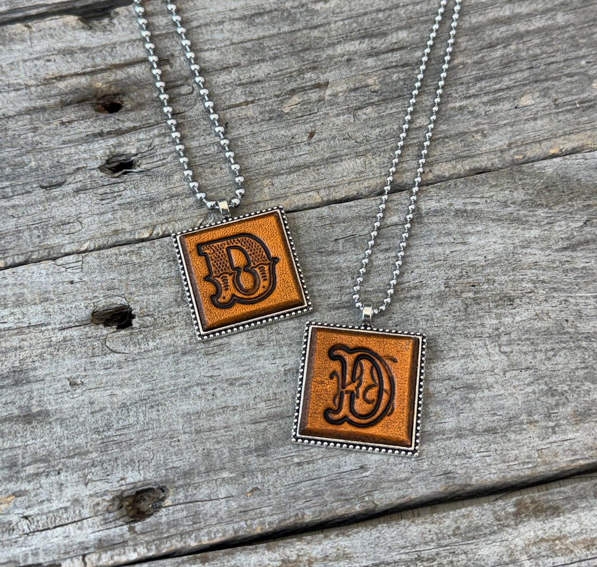 Letter D leather initial necklaces in Western Block and Floral Script fonts on silver ball chains