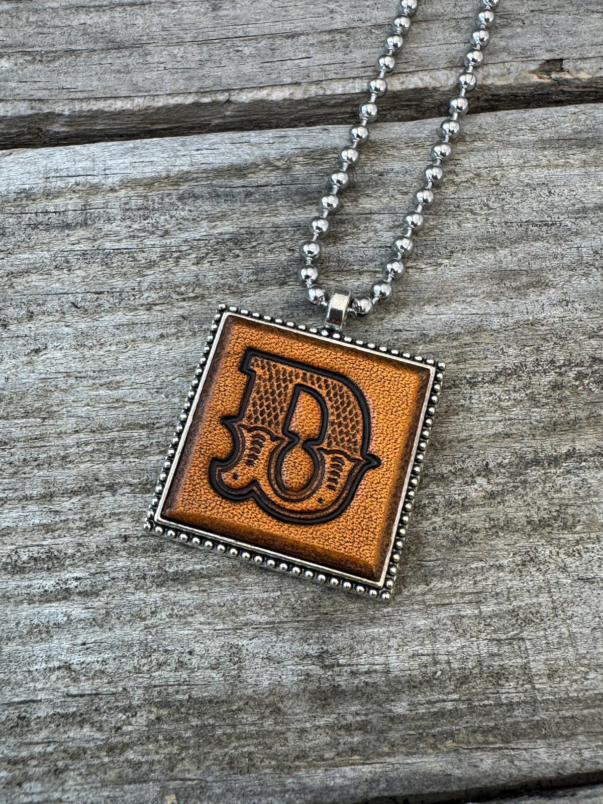 Western Block letter D hand-stamped leather pendant necklace in a silver-tone square frame