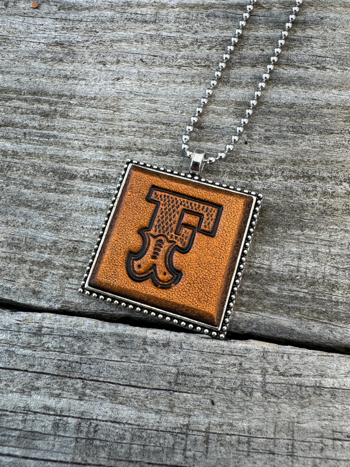 Western Block letter F hand-stamped leather pendant necklace in a silver-tone square frame
