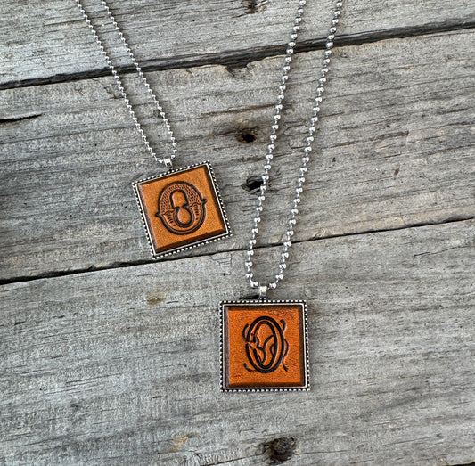 Two handmade Letter O leather initial necklaces in Western Block and Floral Script fonts