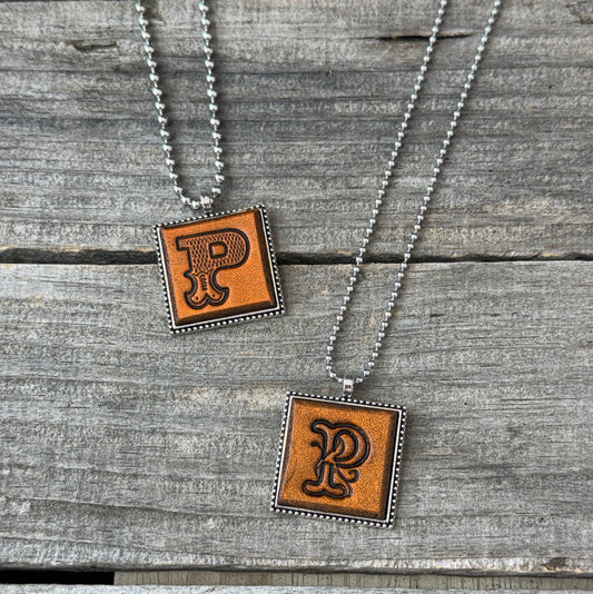 Two handmade Letter P leather initial necklaces in Western Block and Floral Script fonts