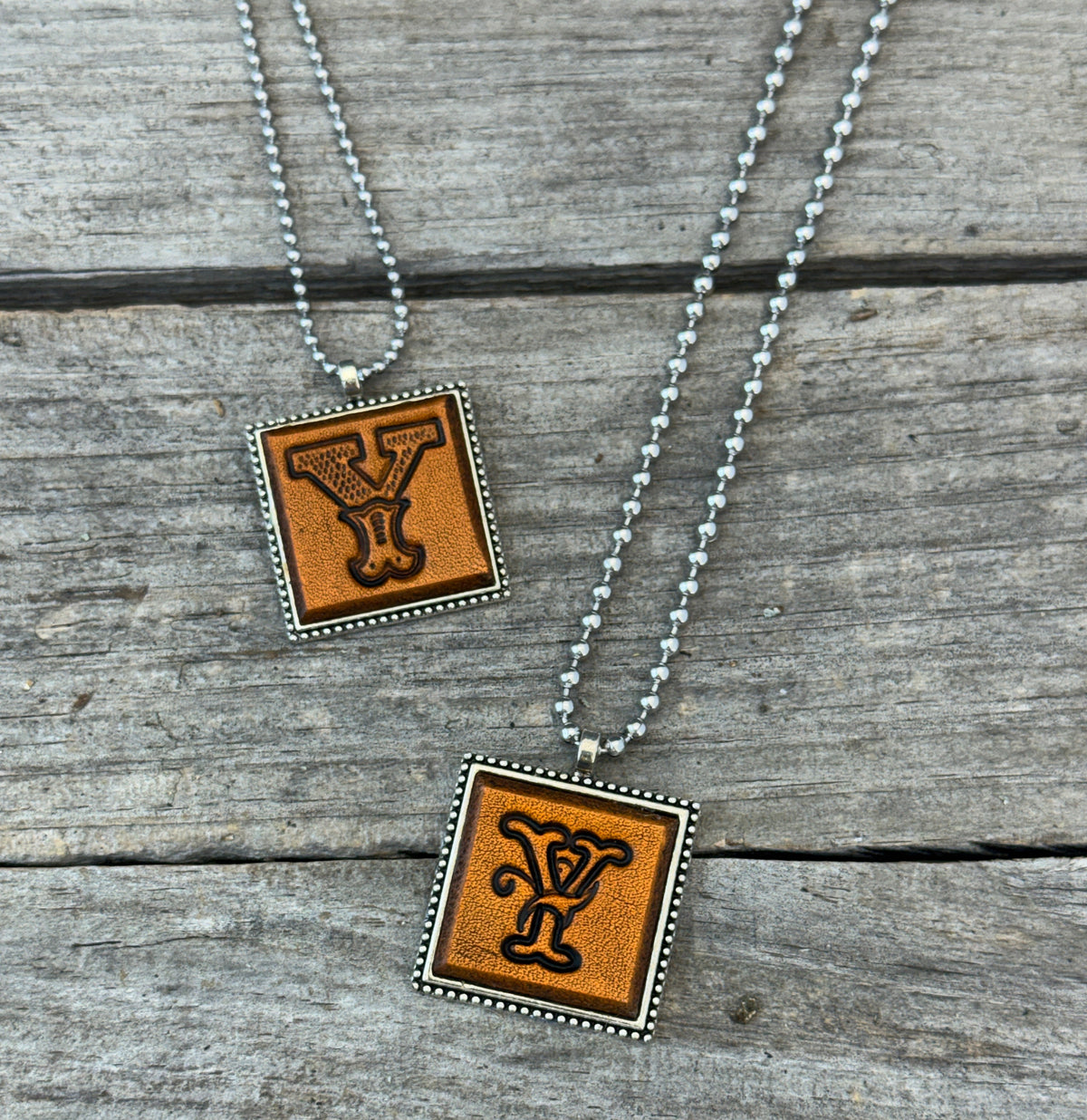 Two handmade Letter Y leather initial necklaces in Western Block and Floral Script fonts