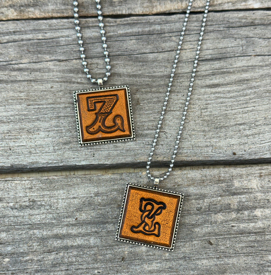 Two handmade Letter Z leather initial necklaces in Western Block and Floral Script fonts