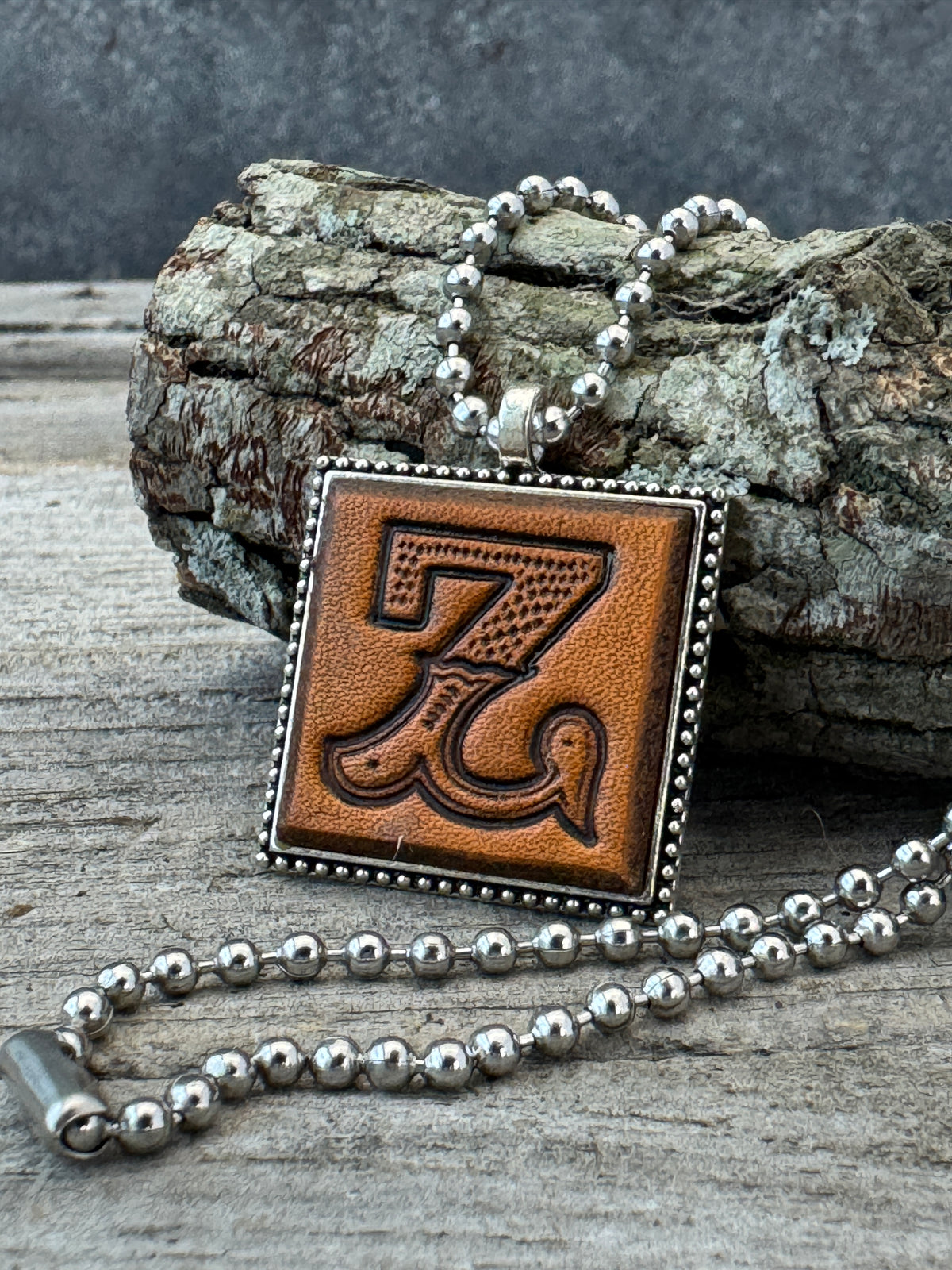 Western Block Letter Z leather initial necklace styled on rustic wood