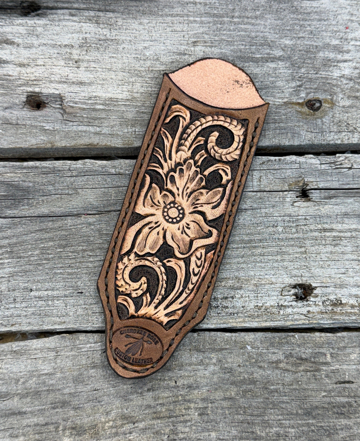 Decorative leather embossment on a wooden surface
