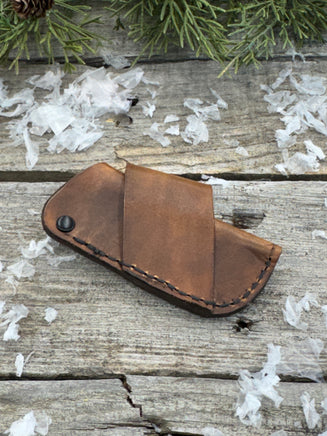 Handmade rustic brown leather knife sheath with black rivet hardware, horizontal carry design for small pocket knives by Cherokee Rose Custom Leather.