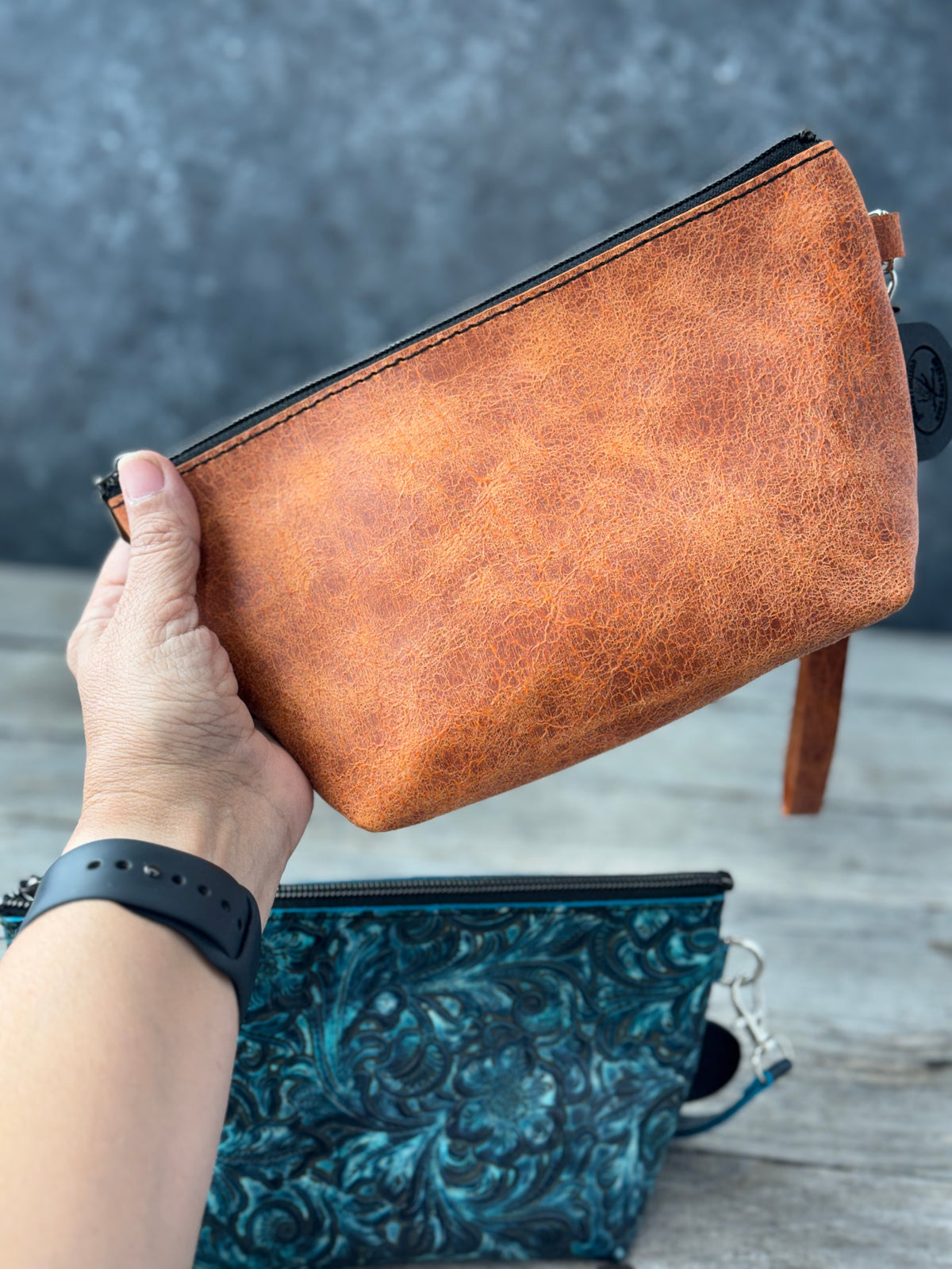 Turquoise embossed floral and rustic orange leather makeup bag wristlets