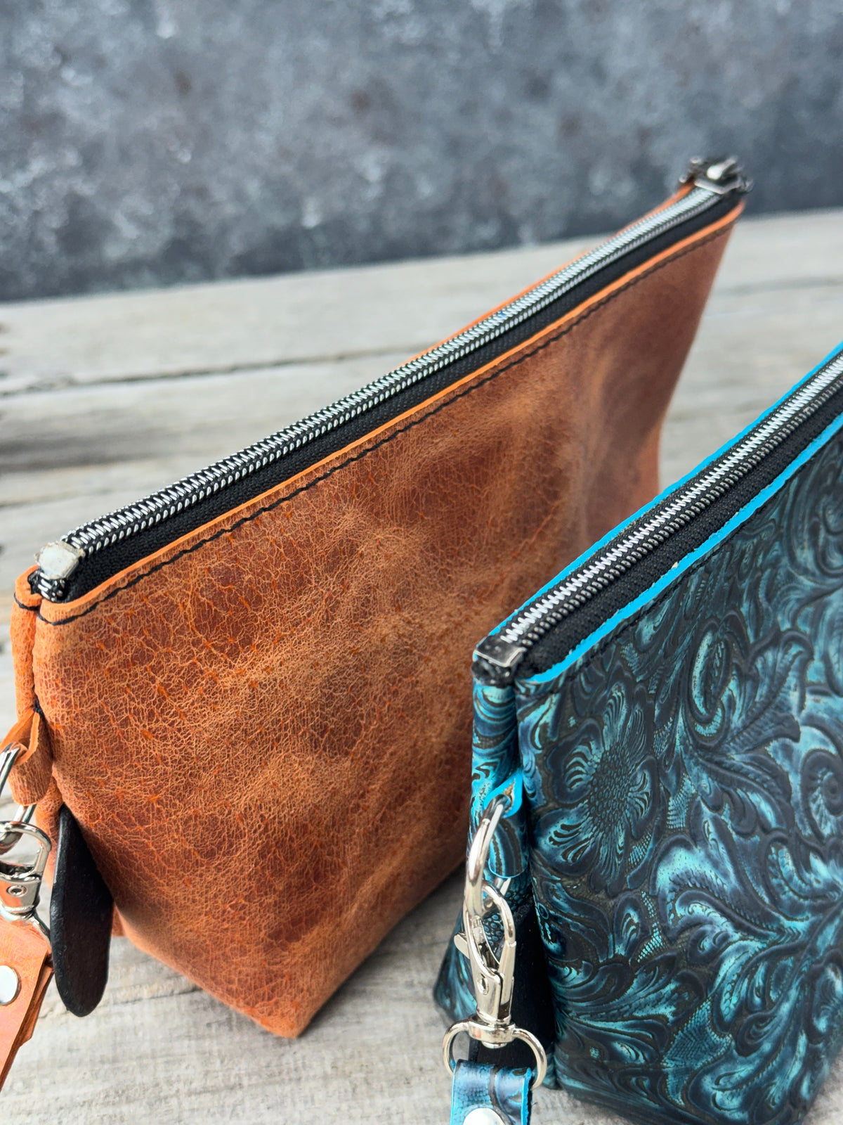 Medium leather makeup organizers with black zippers and detachable straps