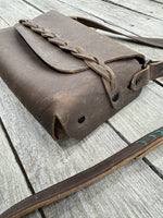 leather bag with braided closure detail minimalist design brown leather purse