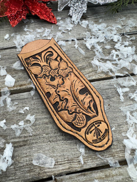 Hand tooled leather cast iron skillet handle cover with oak leaf and acorn carving, light tan dye, handmade by Cherokee Rose Custom Leather in East Texas.