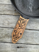 Hand tooled leather cast iron skillet handle cover with oak leaf and acorn carving, light tan dye, handmade by Cherokee Rose Custom Leather in East Texas.