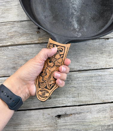 Hand tooled leather cast iron skillet handle cover with oak leaf and acorn carving, light tan dye, handmade by Cherokee Rose Custom Leather in East Texas.