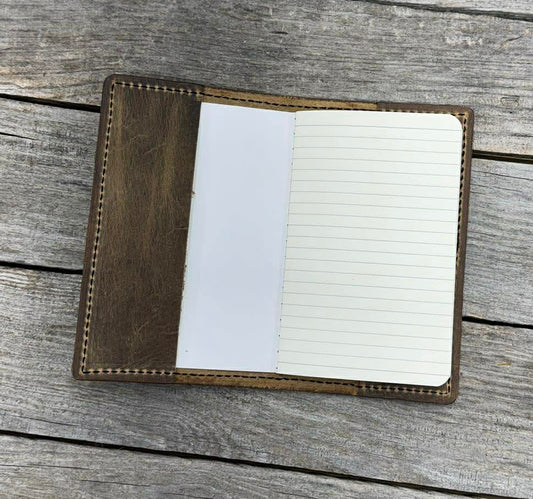 Small notebook with lined pages on a wooden surface