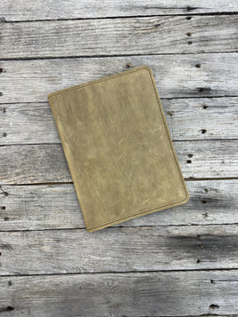 Palomino oil tanned leather composition notebook cover with rustic suede finish and black stitching.