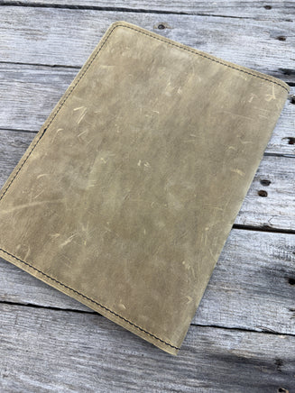 Palomino oil tanned leather composition notebook cover with rustic suede finish and black stitching.