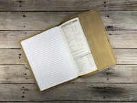 Open notebook with a leather cover on a wooden surface