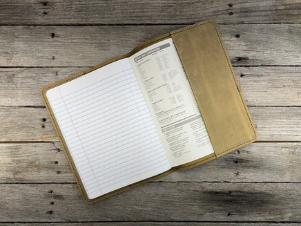 Open notebook with a leather cover on a wooden surface