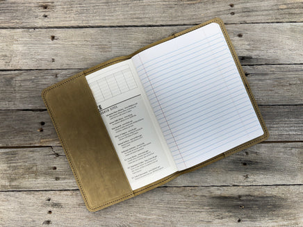 Open notebook with lined pages on a wooden surface