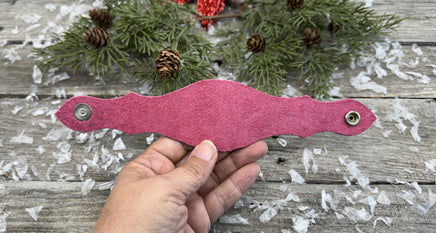 Hand-carved leather cuff bracelet with pink heart and cross design, silver snaps, and pink suede lining, handmade by Cherokee Rose Custom Leather in Texas.