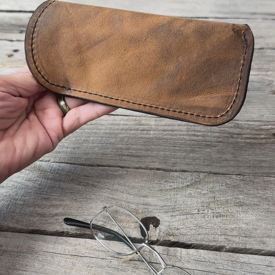 Rustic Brown oil tanned leather eyeglass case shown in hand with exterior details