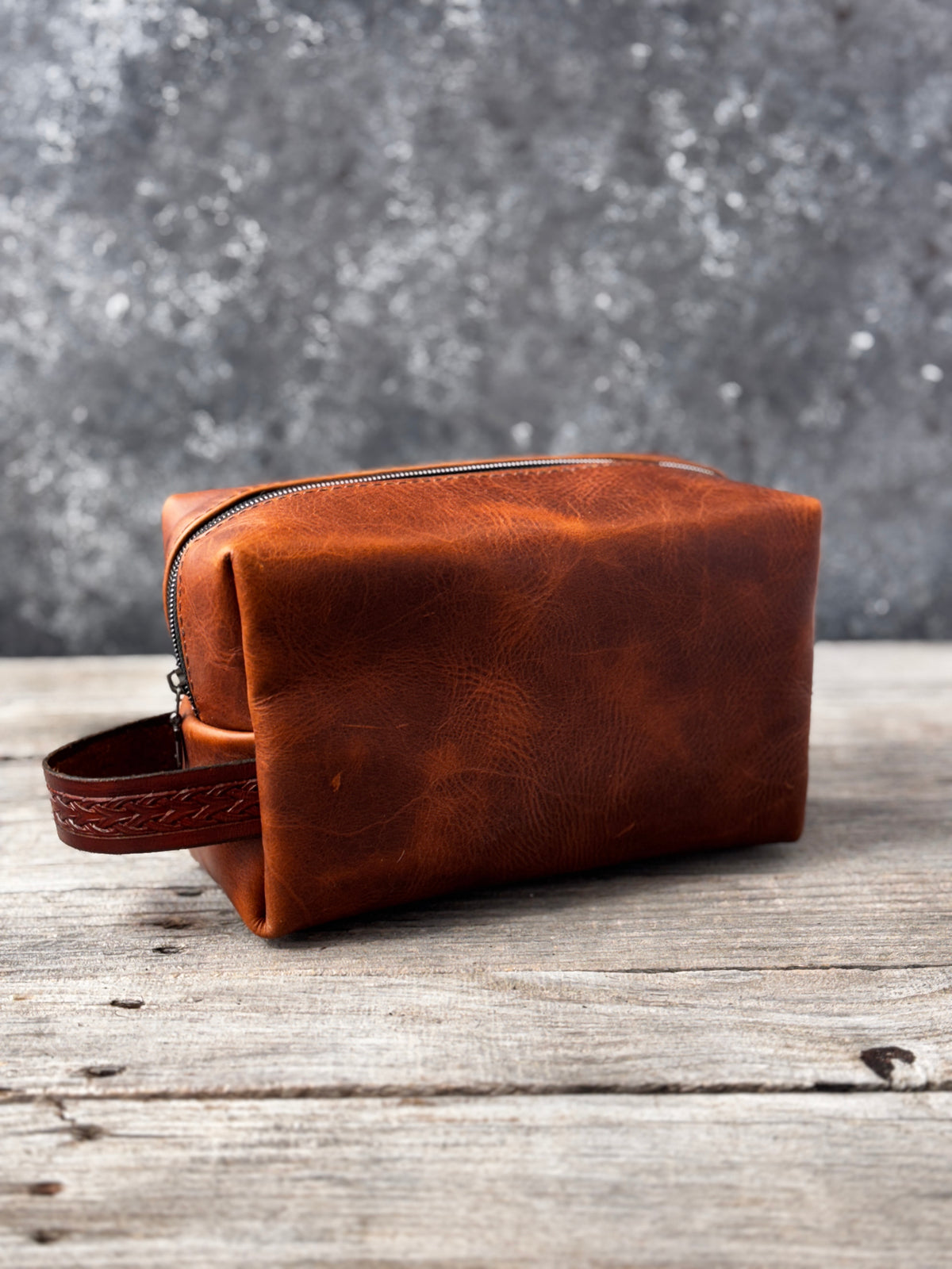 Side profile of rustic brown leather shaving and toiletry travel bag