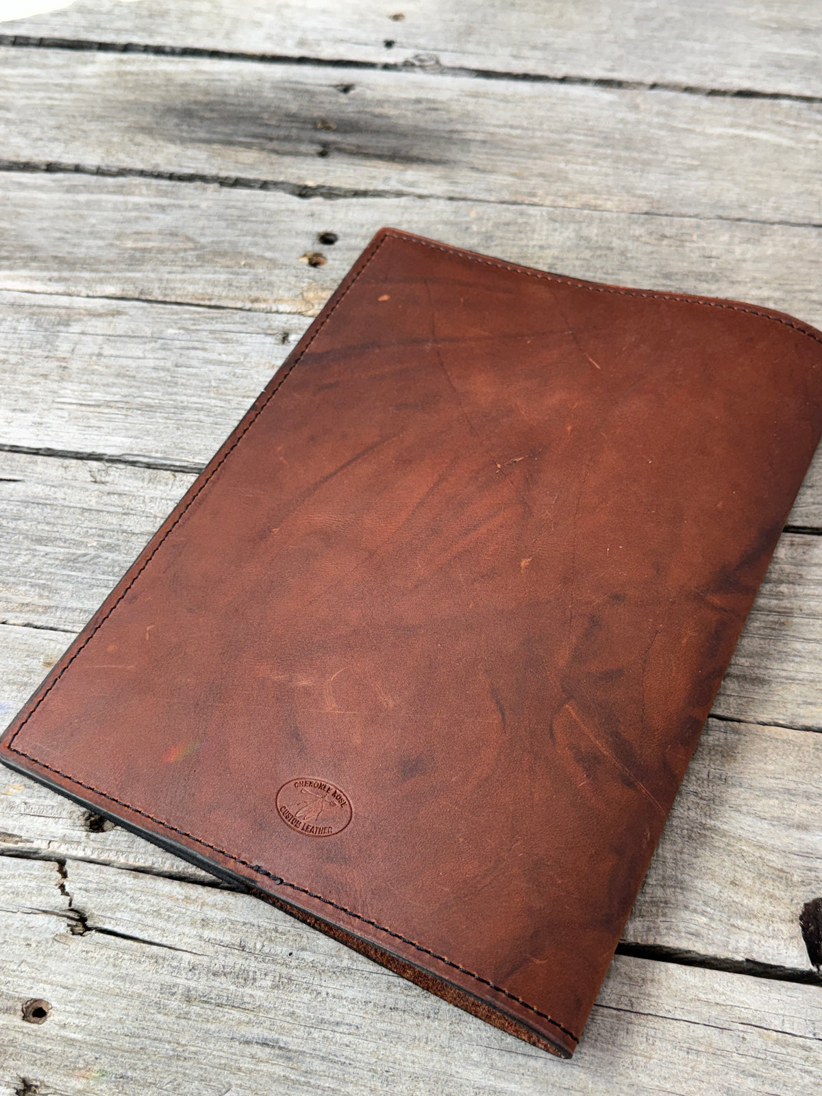Redwood full grain leather composition notebook cover showing natural color variation