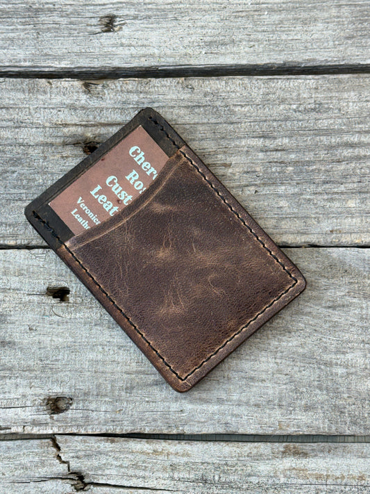 Handmade Brown leather wallet on a wooden surface