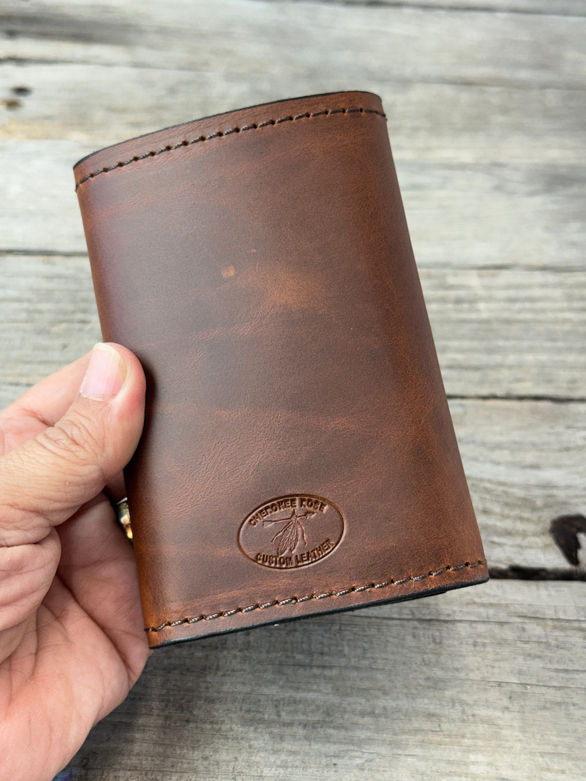 Rustic brown full grain leather trifold wallet showing natural leather grain