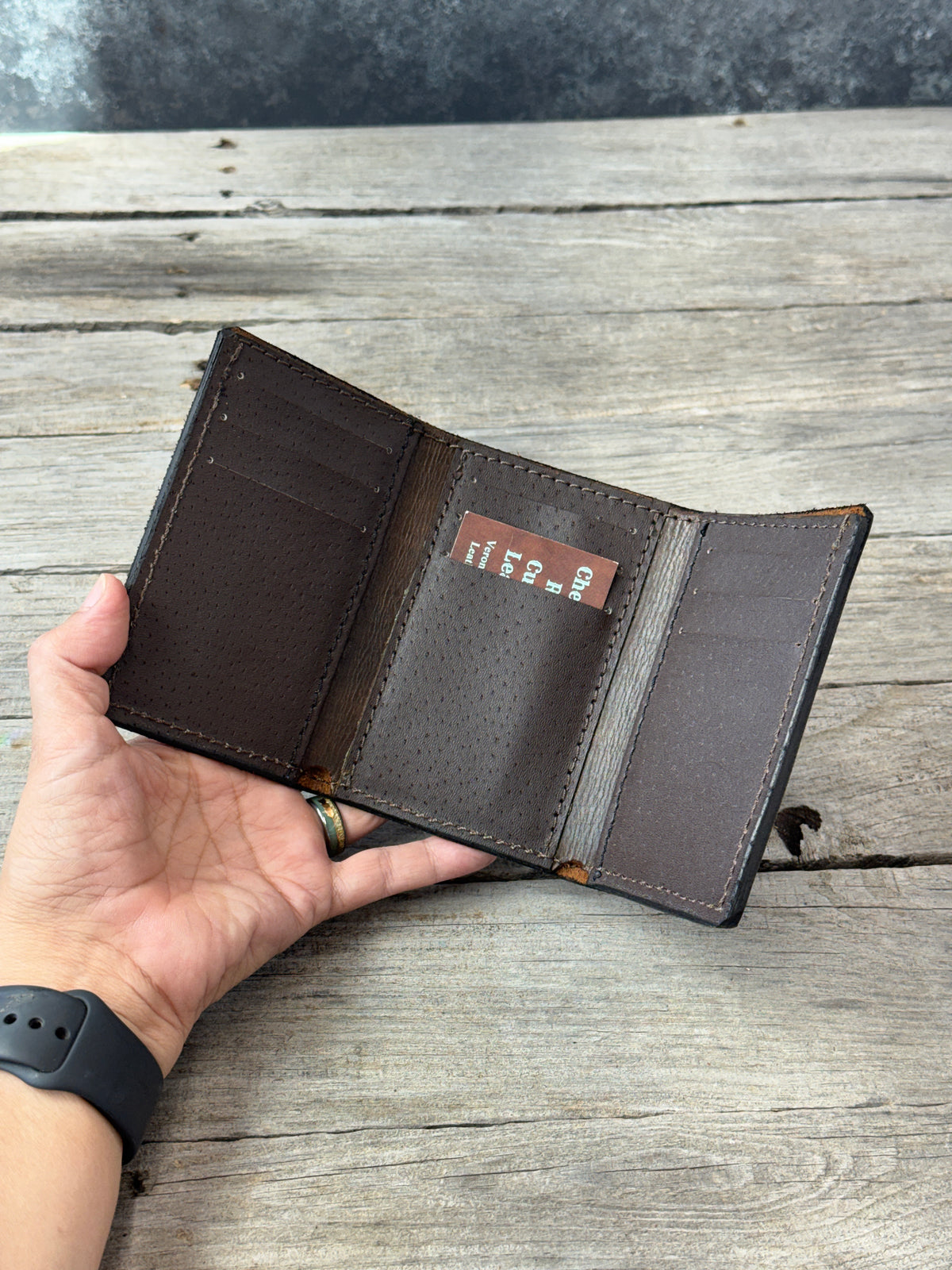 Rustic brown leather trifold wallet with smooth brown pigskin interior