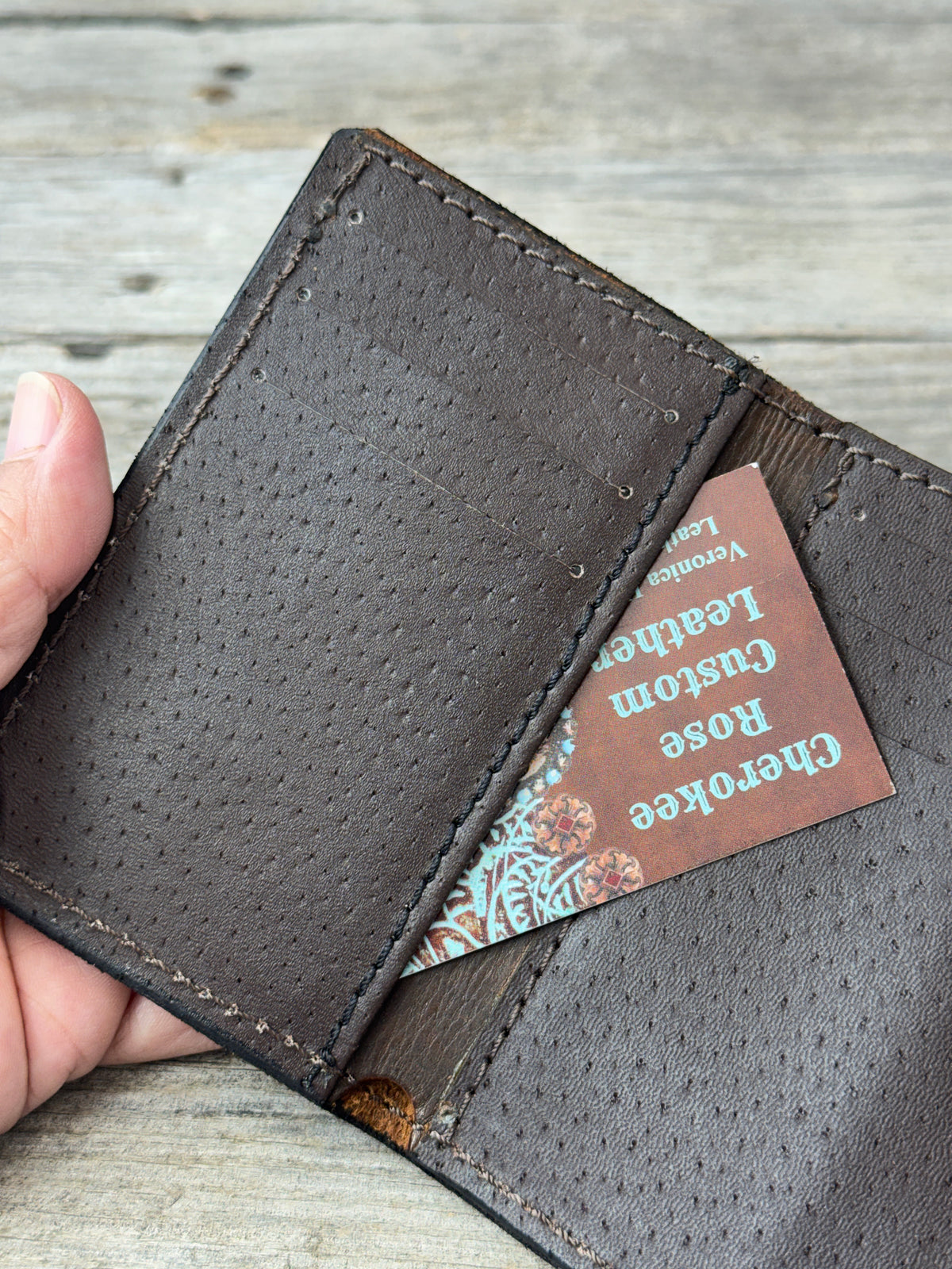 Rustic brown trifold wallet showing pigskin card slots and hidden interior pocket