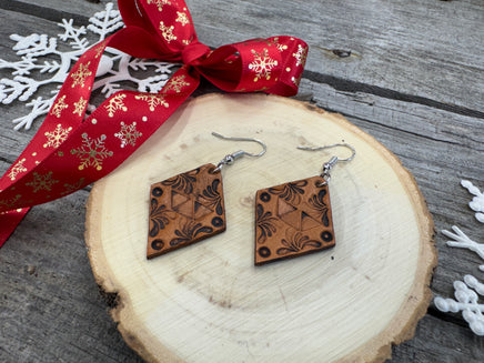 Diamond-shaped hand-stamped leather earrings with scroll design, light brown with sterling silver hooks, handmade by Cherokee Rose Custom Leather in East Texas.