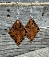 Diamond-shaped hand-stamped leather earrings with scroll design, light brown with sterling silver hooks, handmade by Cherokee Rose Custom Leather in East Texas.