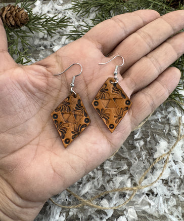 Diamond-shaped hand-stamped leather earrings with scroll design, light brown with sterling silver hooks, handmade by Cherokee Rose Custom Leather in East Texas.