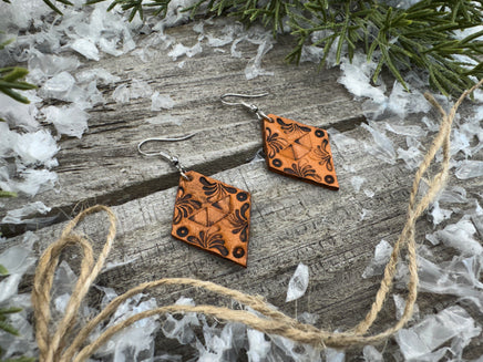 Diamond-shaped hand-stamped leather earrings with scroll design, light brown with sterling silver hooks, handmade by Cherokee Rose Custom Leather in East Texas.