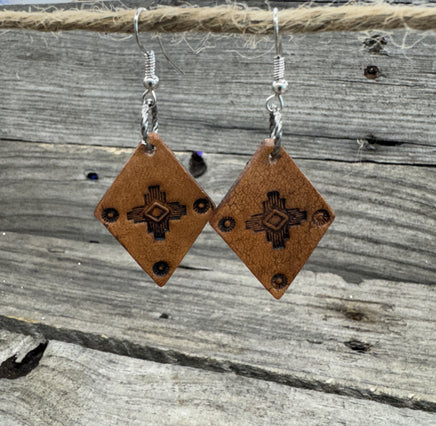 Small diamond-shaped hand-stamped leather earrings with Southwestern sun design and sterling silver hooks, handmade by Cherokee Rose Custom Leather in Texas