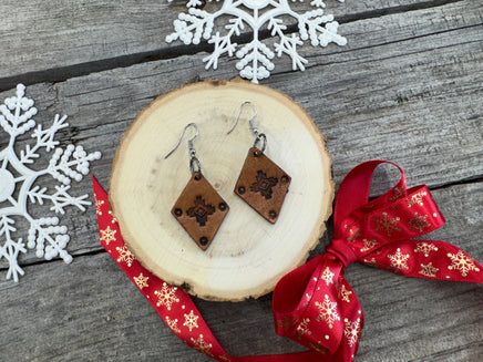 Small diamond-shaped hand-stamped leather earrings with Southwestern sun design and sterling silver hooks, handmade by Cherokee Rose Custom Leather in Texas