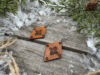 Small diamond-shaped hand-stamped leather earrings with Southwestern sun design and sterling silver hooks, handmade by Cherokee Rose Custom Leather in Texas