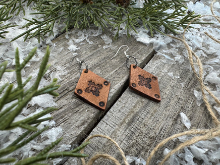Small diamond-shaped hand-stamped leather earrings with Southwestern sun design and sterling silver hooks, handmade by Cherokee Rose Custom Leather in Texas
