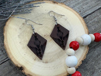 Small dark brown diamond leather earrings with geometric line stamping and sterling silver hooks, handmade by Cherokee Rose Custom Leather in East Texas.