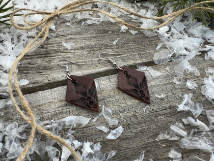 Small dark brown diamond leather earrings with geometric line stamping and sterling silver hooks, handmade by Cherokee Rose Custom Leather in East Texas.