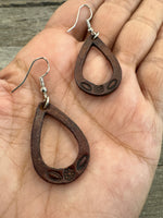 Small hand-stamped leather teardrop earrings with floral and rope design, chocolate brown with sterling silver hooks, handmade by Cherokee Rose Custom Leather in Texas.